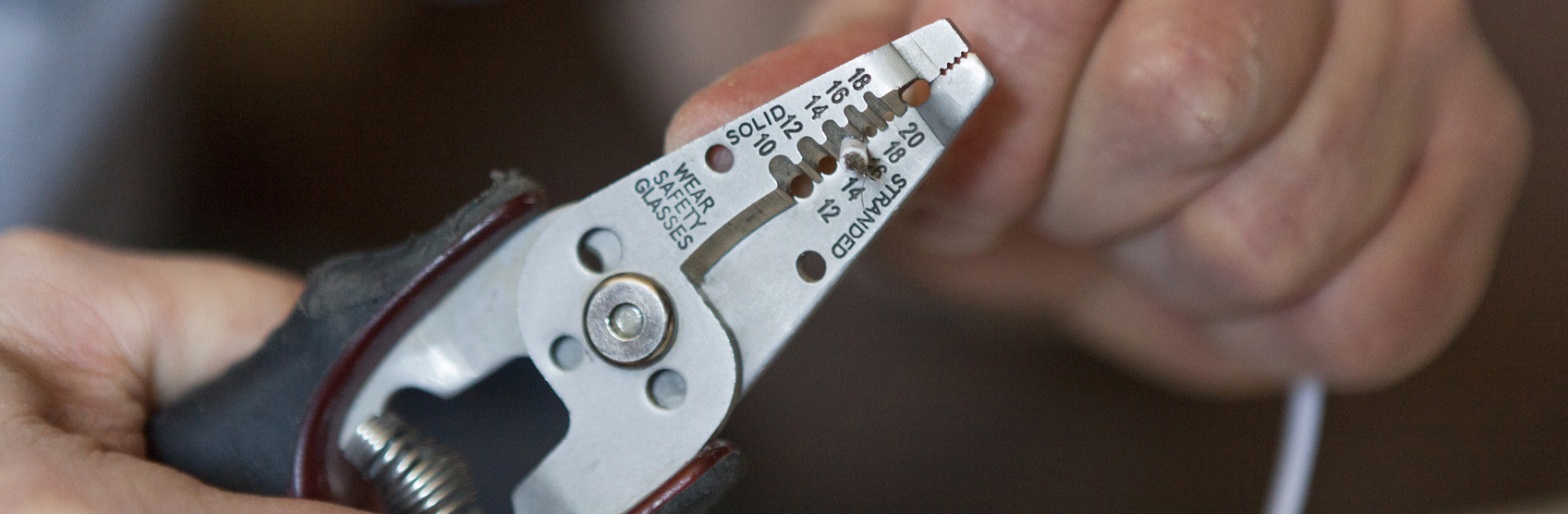 Man preparing wires of a lighting fixture during home renovations.