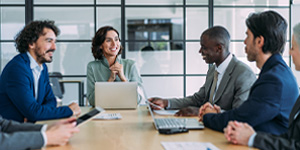 A group of professionals engaged in business meeting in an office setting.