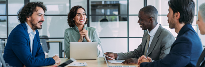 A group of professionals engaged in business meeting in an office setting. A group of professionals engaged in business meeting in an office setting.