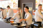 Busy waiter and waitresses working at bar