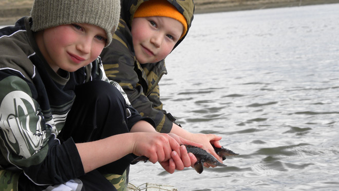 boys releasing juvenile sturgeon boys releasing juvenile sturgeon