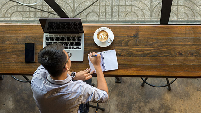 Image of a small business owner working in a cafe Image of a small business owner working in a cafe