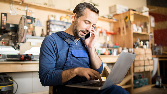 Image of a man working on a laptop