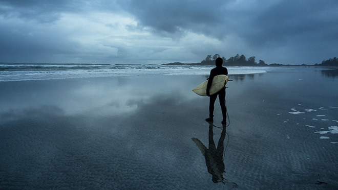 Image of a surfer at Tofino, B.C.'s Chesterman Beach