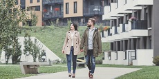 Two people walking in a residential area