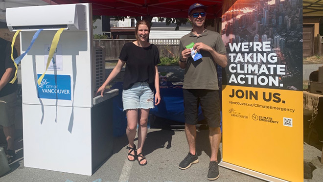 The City of Vancouver's Kari Pocock and Brady Faught demonstrate a heat pump at the Trout Lake Farmers Market