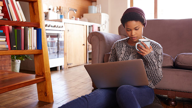 Image of woman drinking coffee and sitting with a laptop Image of woman drinking coffee and sitting with a laptop