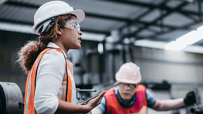 Image of a woman engineer wearing a white hard hat Image of a woman engineer wearing a white hard hat