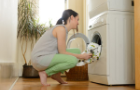 Woman doing laundry using an energy efficient washer dryer
