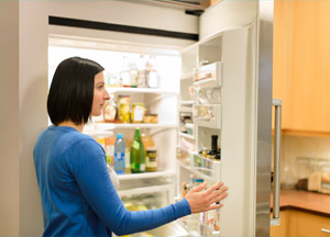 Woman looking in a fridge