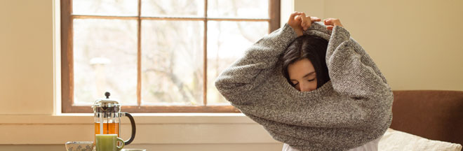 woman-putting-on-sweater-people.jpg woman-putting-on-sweater-people.jpg