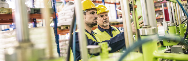 Panoramic shot of industrial coworkers working on some equipment