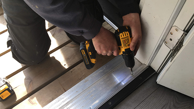 Construction worker uses cordless drill doing renovation work at home. Construction worker uses cordless drill doing renovation work at home.