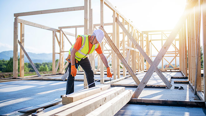 A construction worker framing a new home A construction worker framing a new home