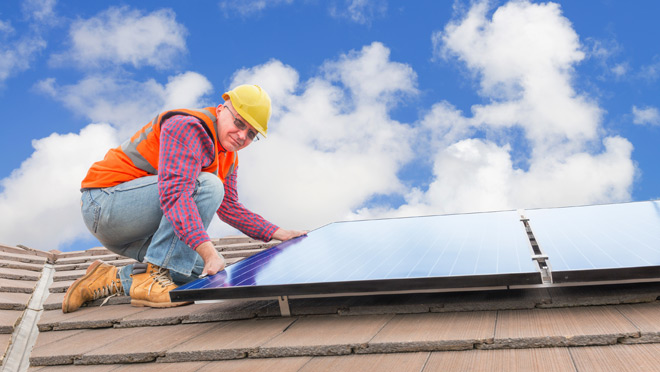 Image of worker installing solar panels Image of worker installing solar panels