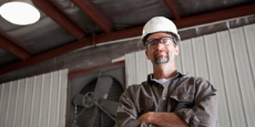 Manual worker in hard hat and protective eyewear