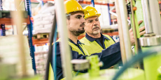 Panoramic shot of industrial coworkers working on some equipment