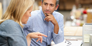 Image of business colleagues working at desk in warehouse