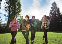 Group of youth running and playing in a field Group of youth running and playing in a field