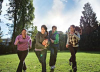 Group of youth running and playing in a field