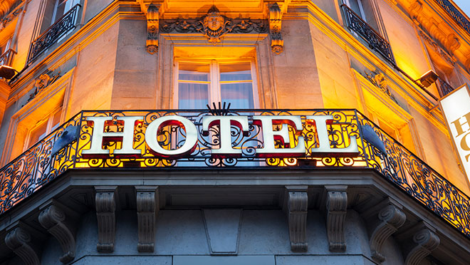 Image of illluminated hotel sign on an old building Image of illluminated hotel sign on an old building