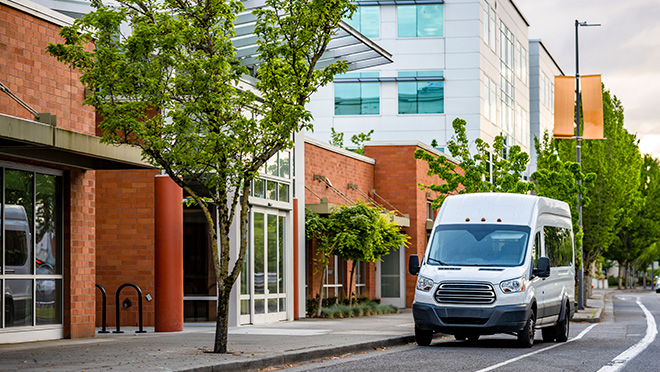 Compact commercial mini van standing on the urban city street