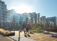 New waterfront sustainable community buildings with sky and lens flare