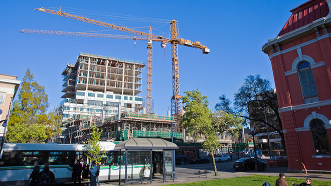 Two cranes construct a building across from Victoria's City Hall Two cranes construct a building across from Victoria's City Hall