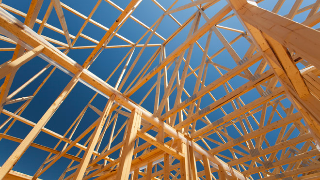 Image of wood-framed house under construction Image of wood-framed house under construction
