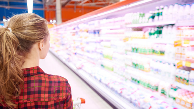 Image of girl walking along supermarket coolers Image of girl walking along supermarket coolers