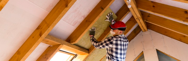 A carpenter renovating the roof of a home