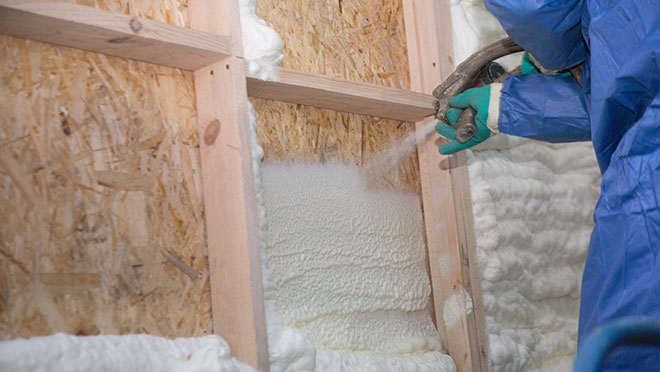 Image of a contractor installing blown insulation