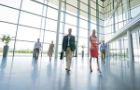 Business people walk through an office building foyer