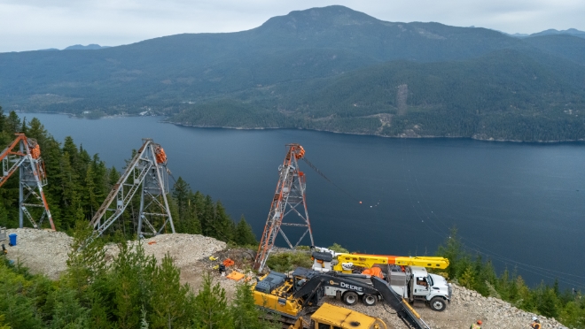 Crews prepare the towers at the Nelson Island side of the line.