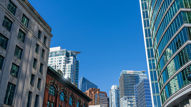 Downtown Vancouver skyline under blue skies Downtown Vancouver skyline under blue skies