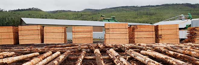 Lumber piled up outside in a lumberyard Lumber piled up outside in a lumberyard