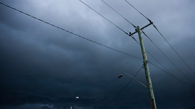 Image of power lines under black storm clouds Image of power lines under black storm clouds