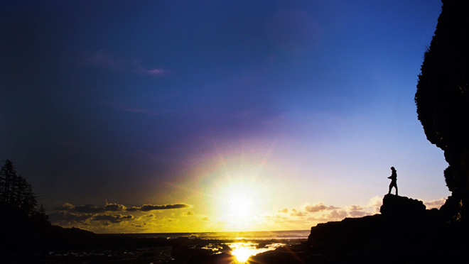 Image of silhouetted seaside scene and setting sun Image of silhouetted seaside scene and setting sun
