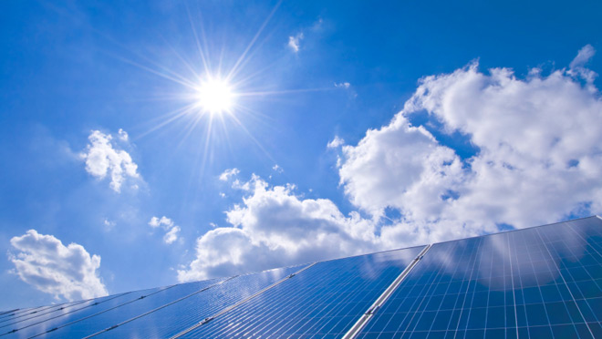 Image of solar panels under a sunny, blue sky Image of solar panels under a sunny, blue sky
