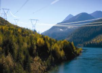 Transmission towers running down the mountain across the water Transmission towers running down the mountain across the water