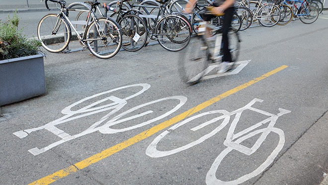 Image of a cyclist riding on a downtown Vancouver bike lane Image of a cyclist riding on a downtown Vancouver bike lane