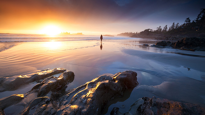 Figure standing on a Vancouver Island beach at sunset