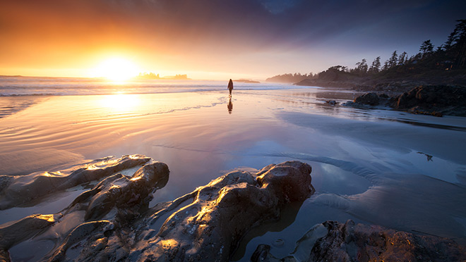 Figure standing on a Vancouver Island beach at sunset Figure standing on a Vancouver Island beach at sunset