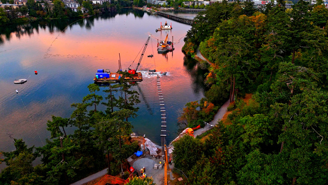 Marine construction activity in a harbour at dusk.