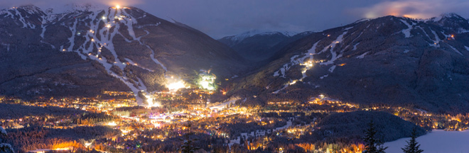 Whistler resort at night View from nearby mountain of Whistler village, Blackcomb and Whistler mountain ski areas at night.