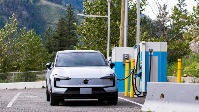 Electric vehicle at a BC Hydro charging station in Lytton, B.C. with mountains and trees in the background. Electric vehicle at a BC Hydro charging station in Lytton, B.C. with mountains and trees in the background.