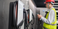 Engineer inspecting an electric vehicle charging station.