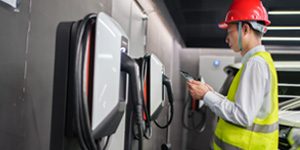 Engineer inspecting an electric vehicle charging stations.