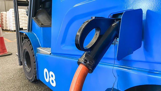 An electric forklift being charged