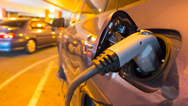 Image of an EV charging in a parking garage